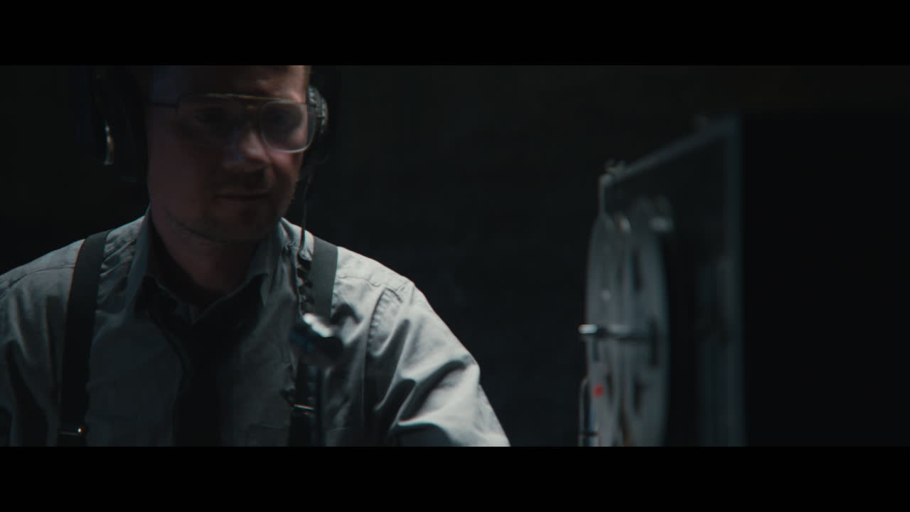 An intelligence officer listens to the wiretap recordings