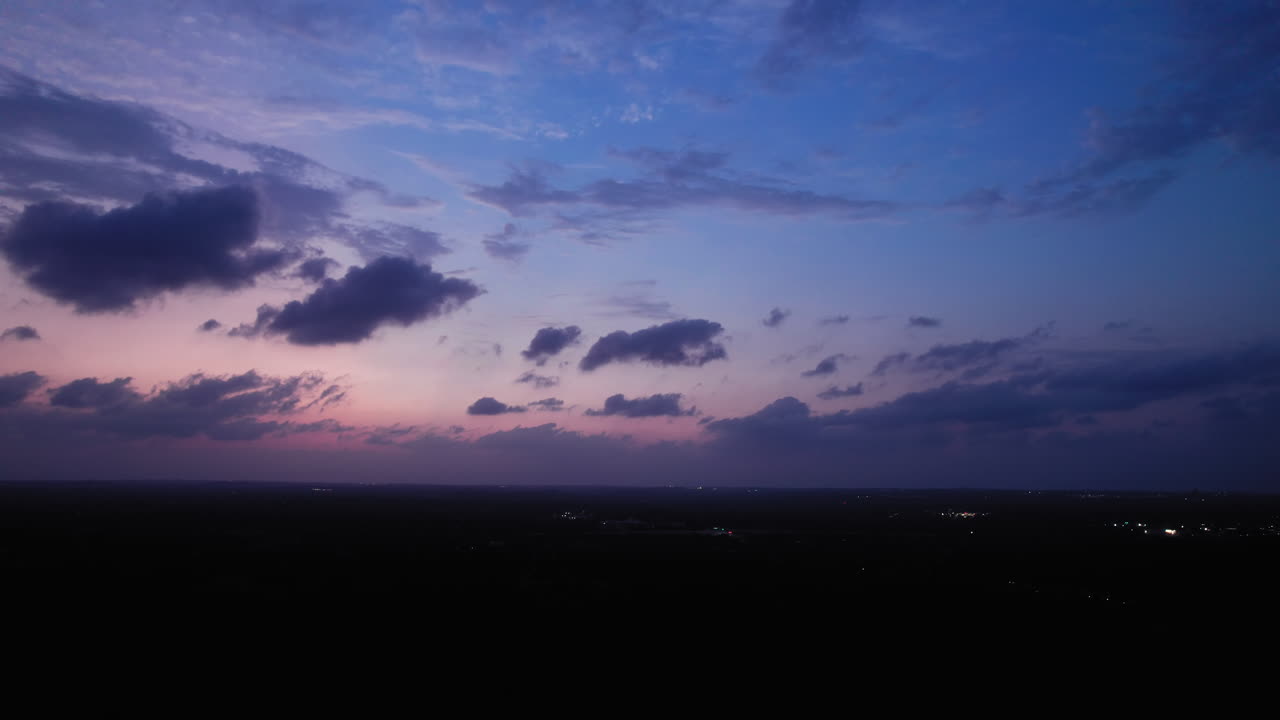 Beautiful Blue Hour cloudscape, clouds drifting across the sky over an Austin, Texas suburb