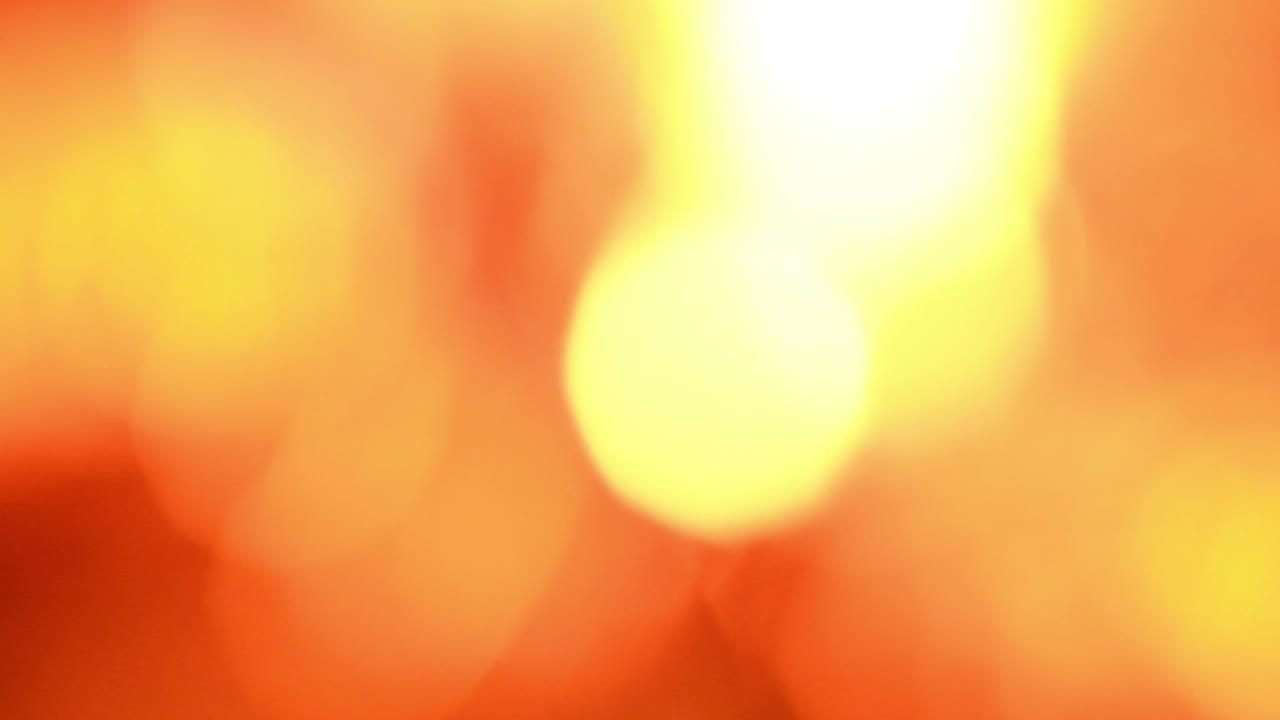 Orange and red coals texture blurred background. Contains the sound of crackling and chirping crickets. Side view.