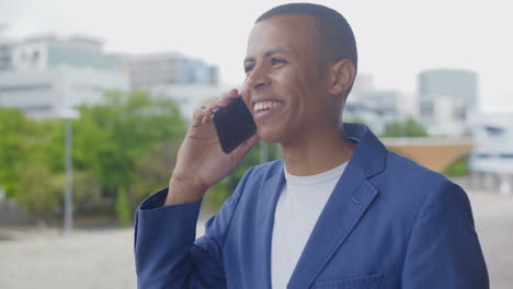 cheerful african american businessman talking on phone.