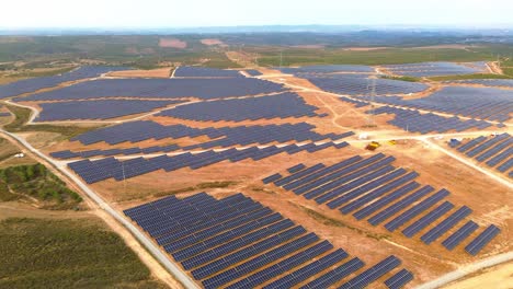 aerial-view-of-solar-farm-over-dry-land,-portugal,-4k