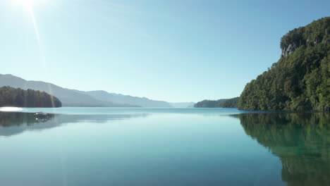 aerial - through trees onto correntoso lake, neuquen, argentina, forward reveal