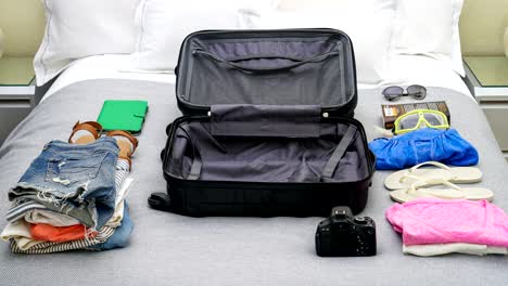 4k stop motion animation of empty suitcase being filled up with women's clothes