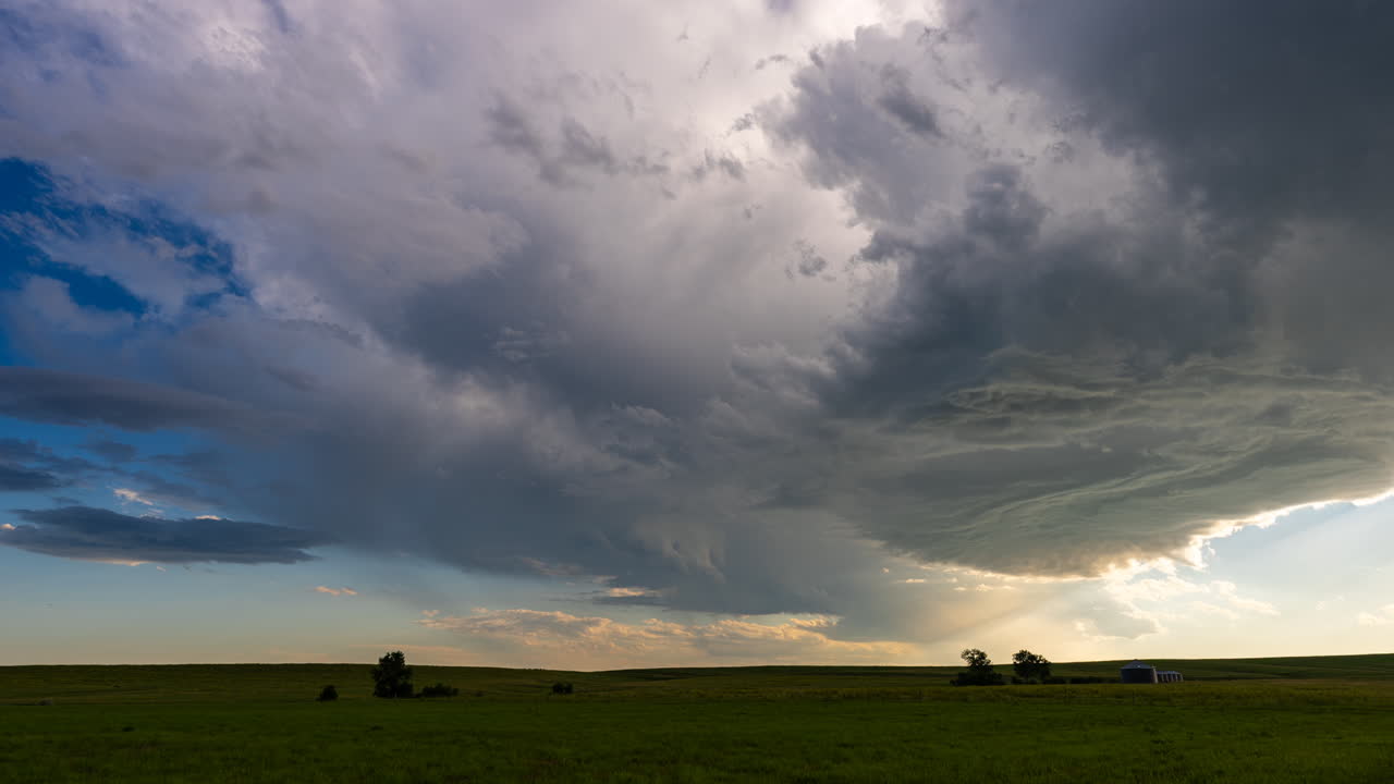 Beautiful scene as storm clouds move across blue skies over lush grassy fields