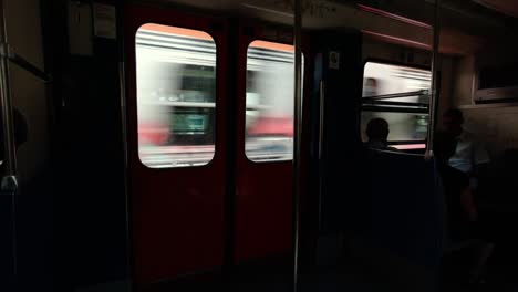 inside view from the window of the moving overground train carriage in athens, greece