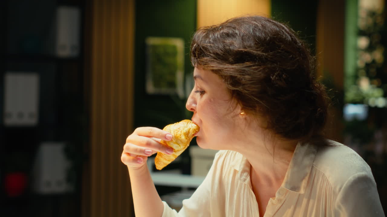 Vertical Video Stressed employee works late and uncontrollably eating a snack