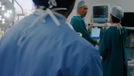 surgeon using digital tablet while colleagues interacting in the background