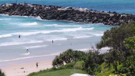 scenic beach view with visitors enjoying the waves