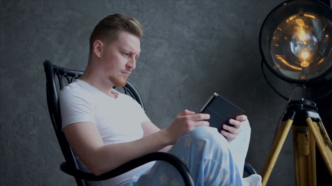 Man Reading on a Rocking Chair