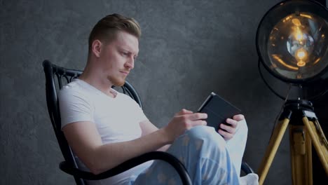 man reading on a rocking chair