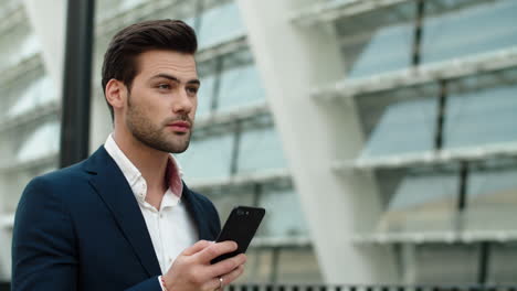 Portrait-businessman-walking-at-street.-Man-smiling-in-stylish-suit-outdoors