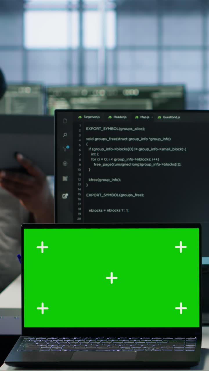 Laptop with Green Screen Display in Tech Office with Coder