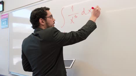 higher education: professor writing on a whiteboard