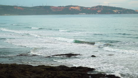 Coast-of-sand-dunes-in-South-of-Vietnam-with-sea-waves-crashing-on,-static-view