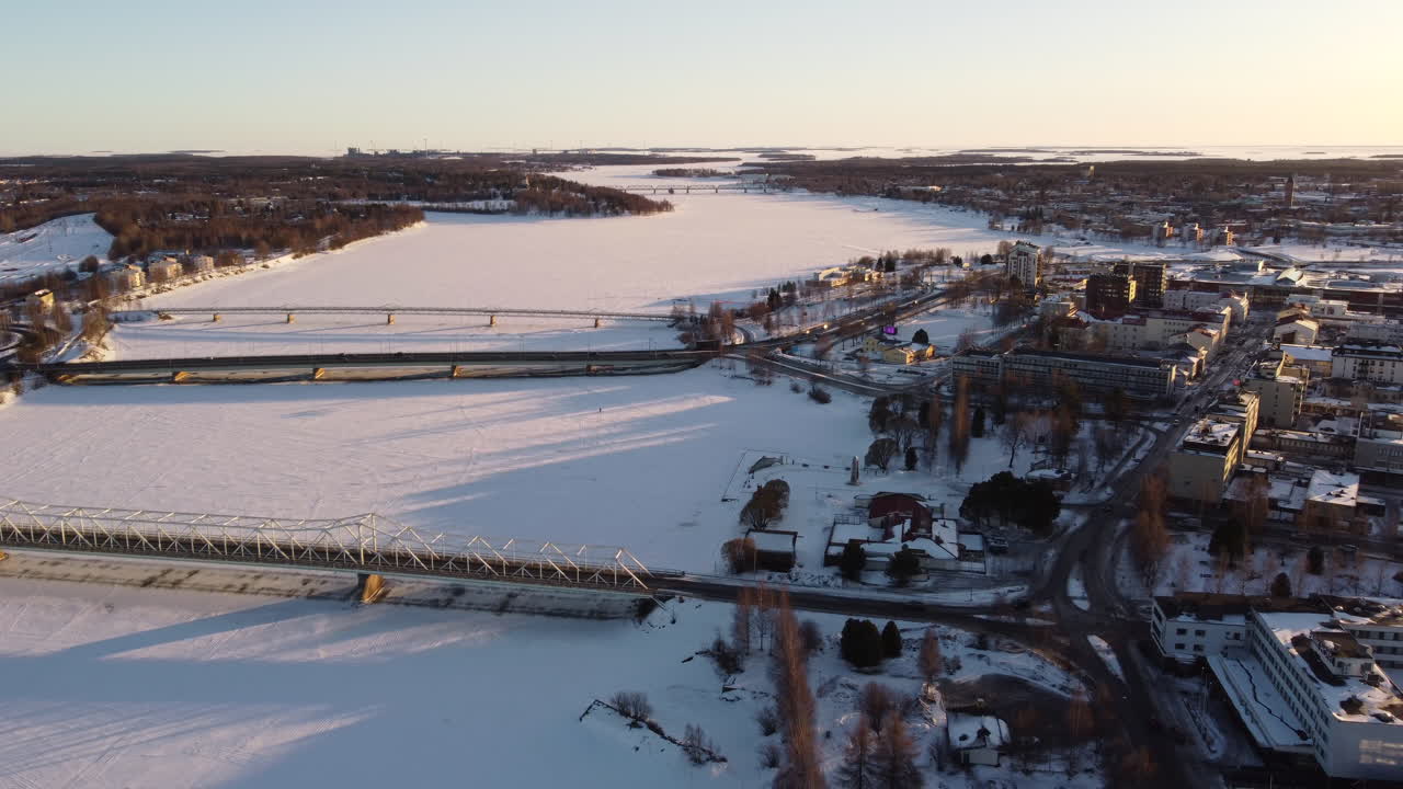 City of Tornio in winter on banks of frozen Torne River, Finland. Aerial backwards