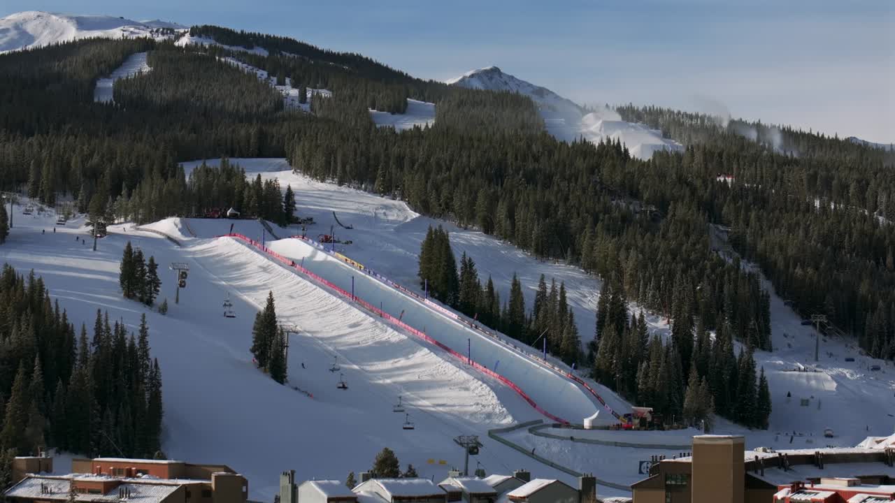 Copper Mountain Resort center village aerial drone chairlifts gondola Ikon Pass Alterra snowboarding snow ski riding trails morning winter solstice December halfpipe snow guns trees circle left