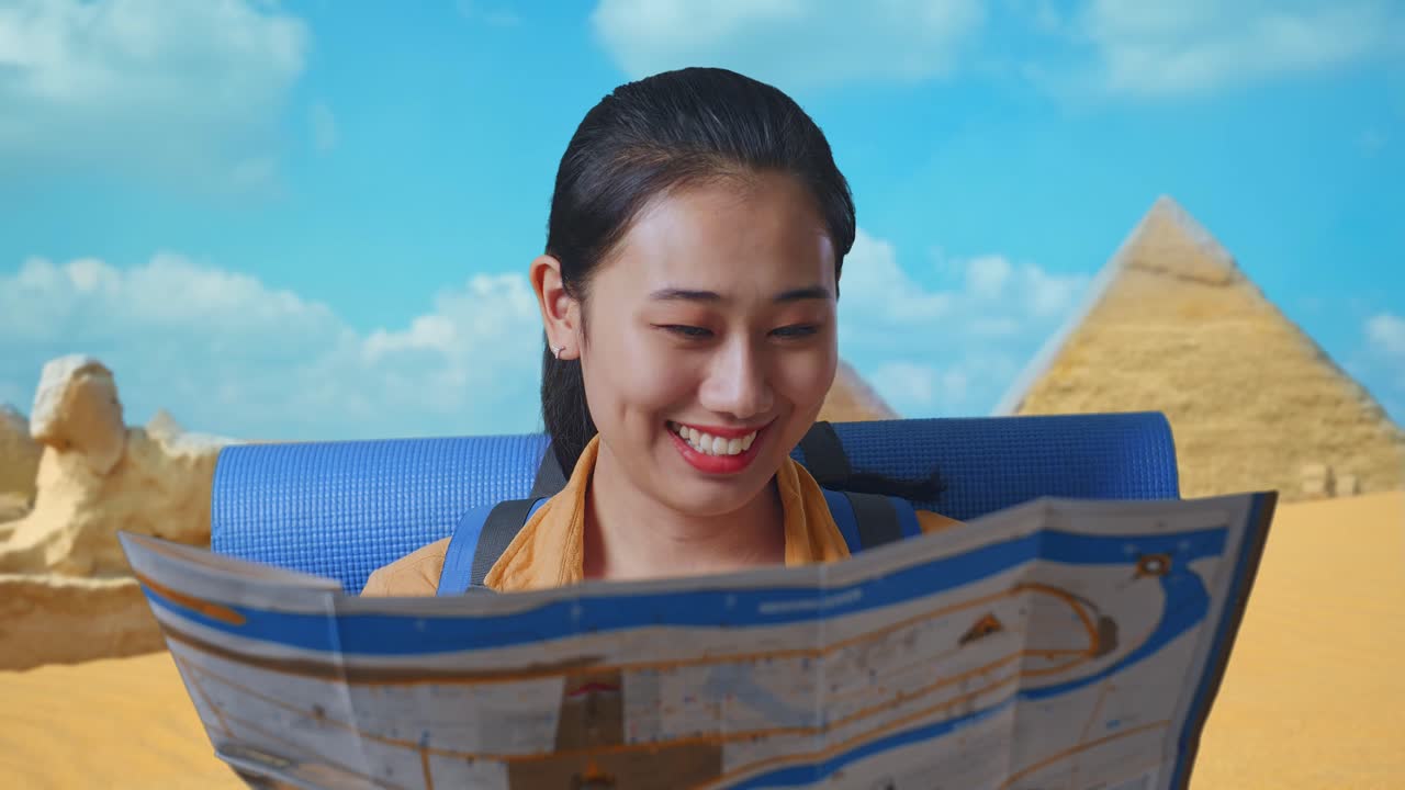 Close Up Of Asian Female Hiker With Mountaineering Backpack Looking At The Map Then Looking Around While Traveling In Pyramid Of Giza