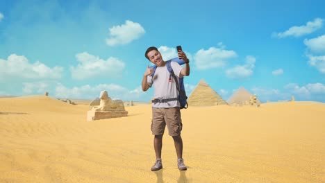 man taking a selfie in front of the pyramids