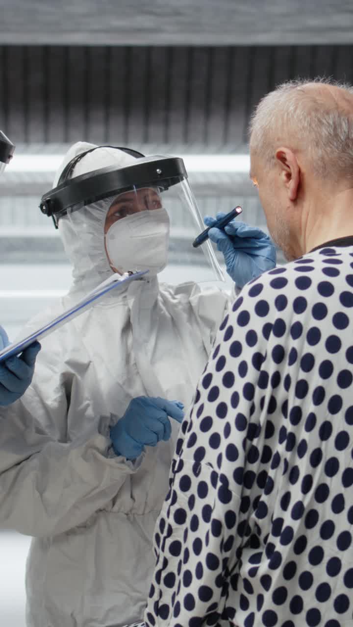 Vertical Video Scientists treating patient in quarantine with experimental antiviral drugs
