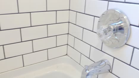 new remodeled bathtub shower with white subway tiles.