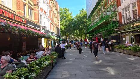 people walking and dining on a lively street