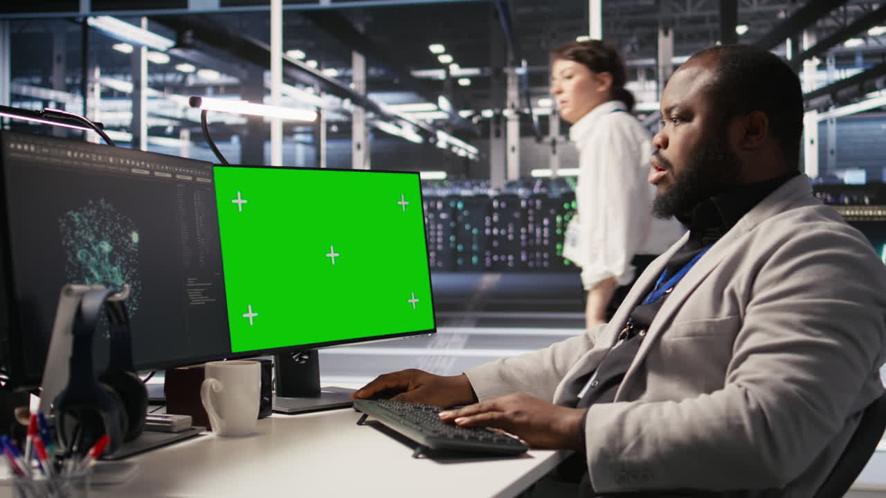 Vertical video Data center programmer working on green screen desktop PC