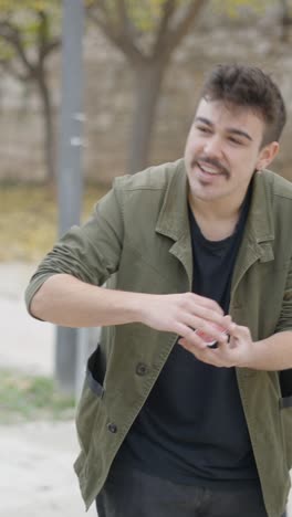 young magician performing card tricks outdoors