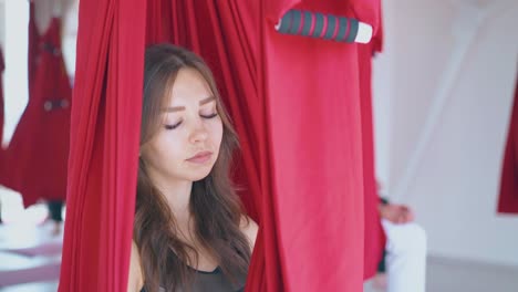 nice-dark-haired-lady-sits-with-closed-eyes-and-meditates