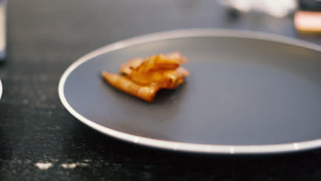 cooked piece of sliced ham sits on plate