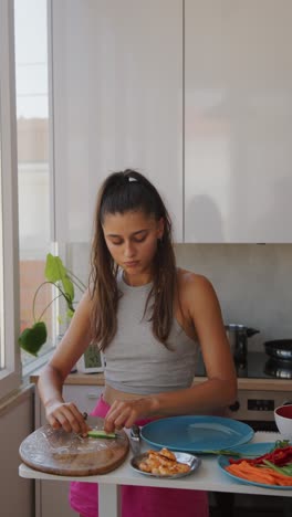 woman preparing healthy spring rolls in a bright kitchen