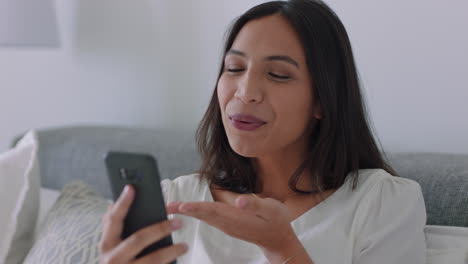 beautiful mixed race woman having video chat using smartphone blowing kiss enjoying chatting to friend waving goodbye