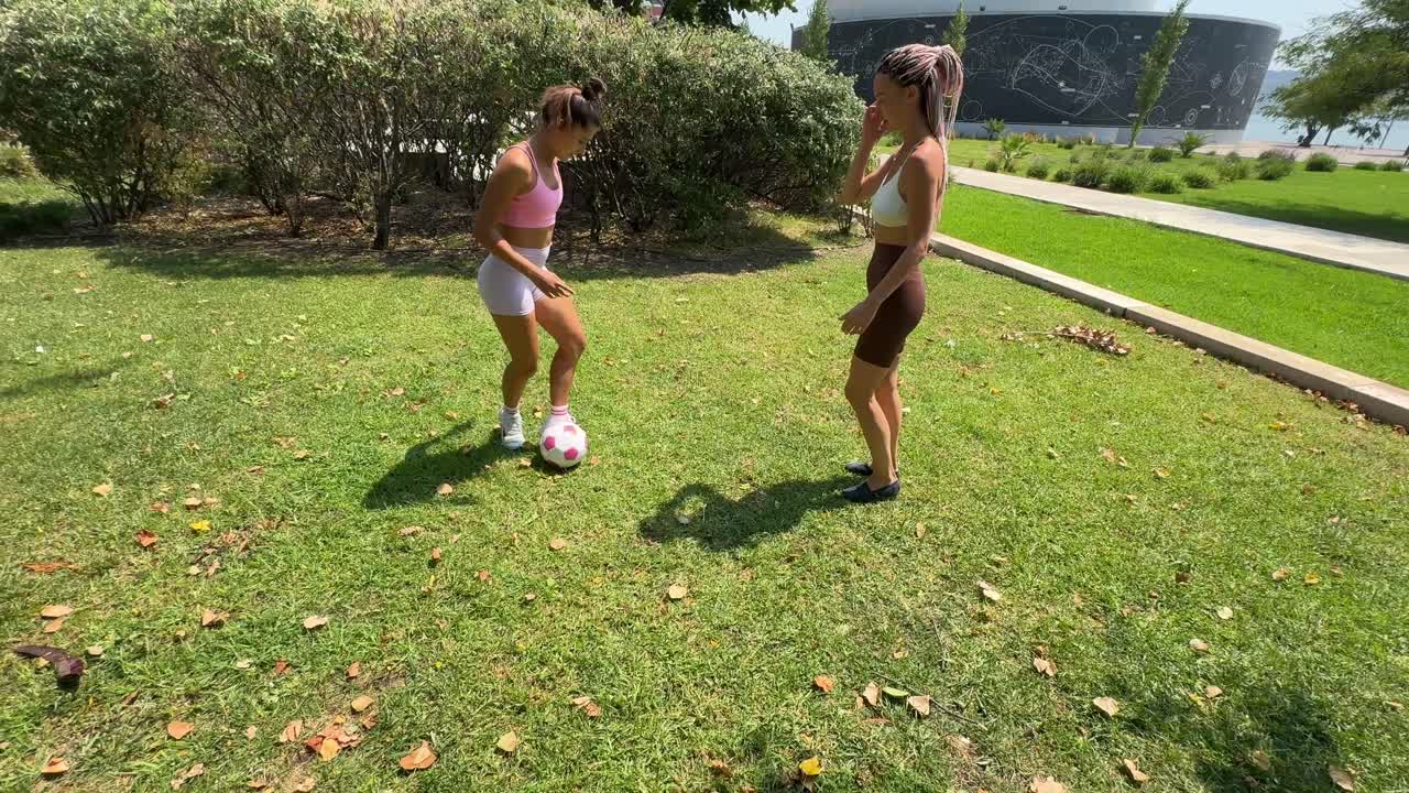 Two Women Playing Soccer in the Park