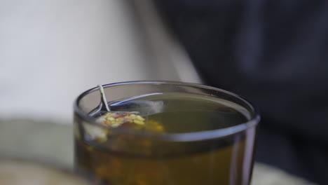 herbal tea bag steeping and infusing hot water