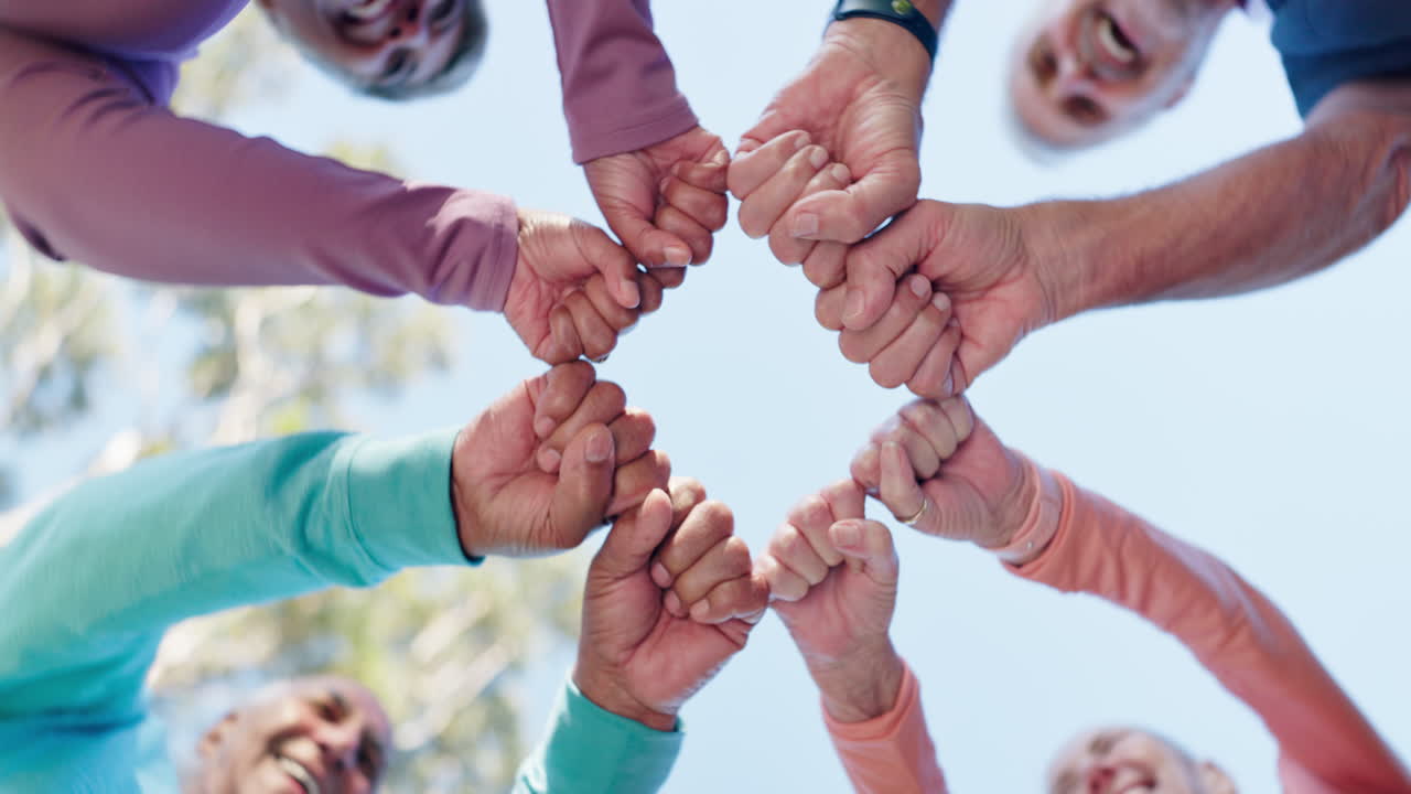 Seniors showing teamwork and unity by putting their hands together