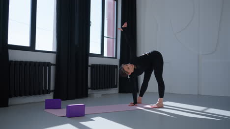 woman practicing yoga in a studio