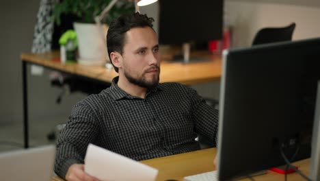 portrait of focused professional typing on pc keyboard indoors at office