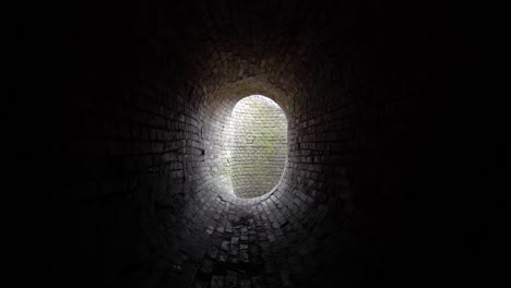 old abandoned oval brick tunnel  of the 19th century in the day.