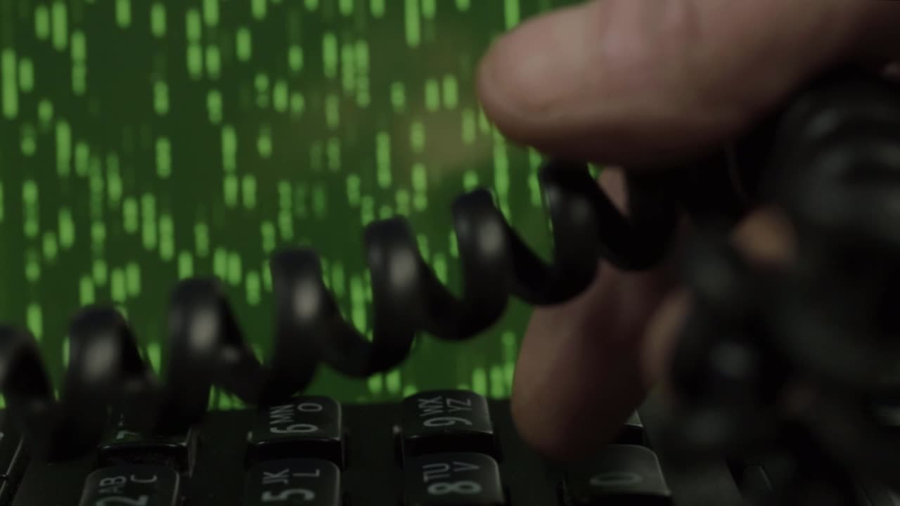 Hand using black desk phone with green data animation