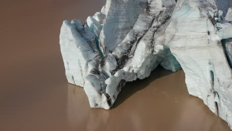 Birds-eye-view-of-majestic-iceberg-floating,-Breidamerkurjokull-glacier-tongue-in-Iceland.-Aerial-view-of-ice-block-formation-in-Vatnajokull-national-park.-Climate-change.-Beauty-in-nature