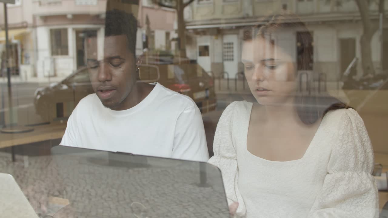 랩톱을 사용하고 이야기하는 진지한 동료