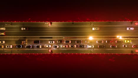 top-down drone shot of twin river bridges with cars above yangtze river at night in chongqing, yuzhong district, china