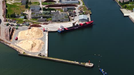 an aerial view captures a cargo ship docked at a port