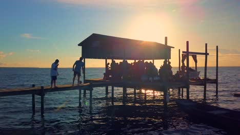 a fun family feeling is portrayed during a crab boil out on a dock over the water