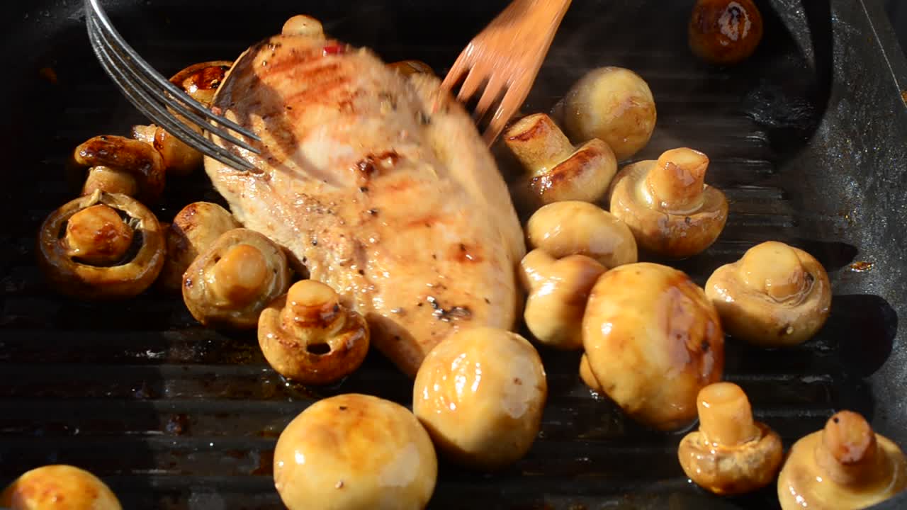 We fry mushrooms with chicken on a grill. We cook a dish