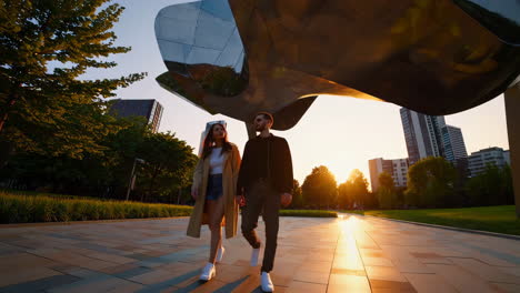 couple walking in a city park at sunset
