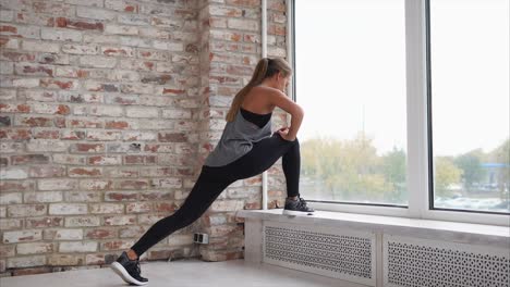 woman stretching by the window