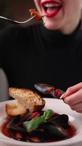 woman eating mussels soup