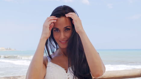 pretty young lady leaning against beach railing