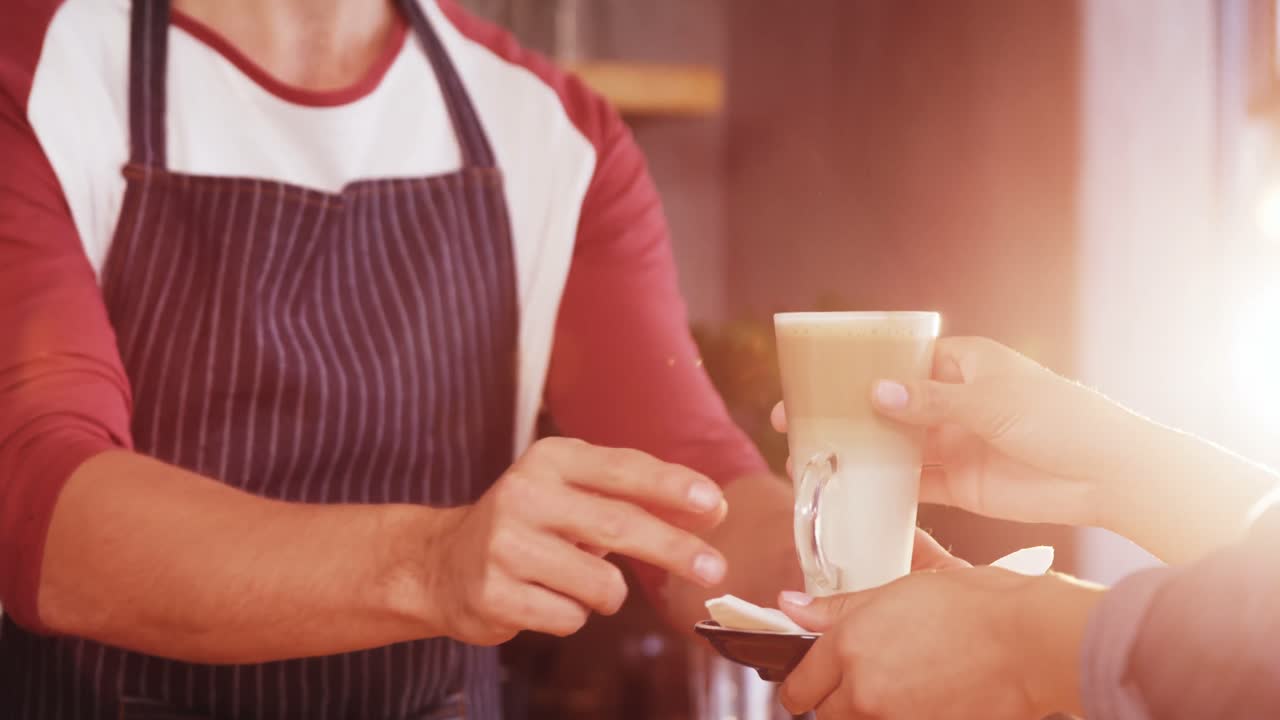 Close up of customer taking his coffee at counteer
