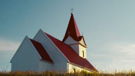handheld-shot-of-girl-in-front-of-church-in-iceland-at-sunset